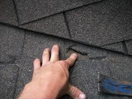 man's hands repairing roof